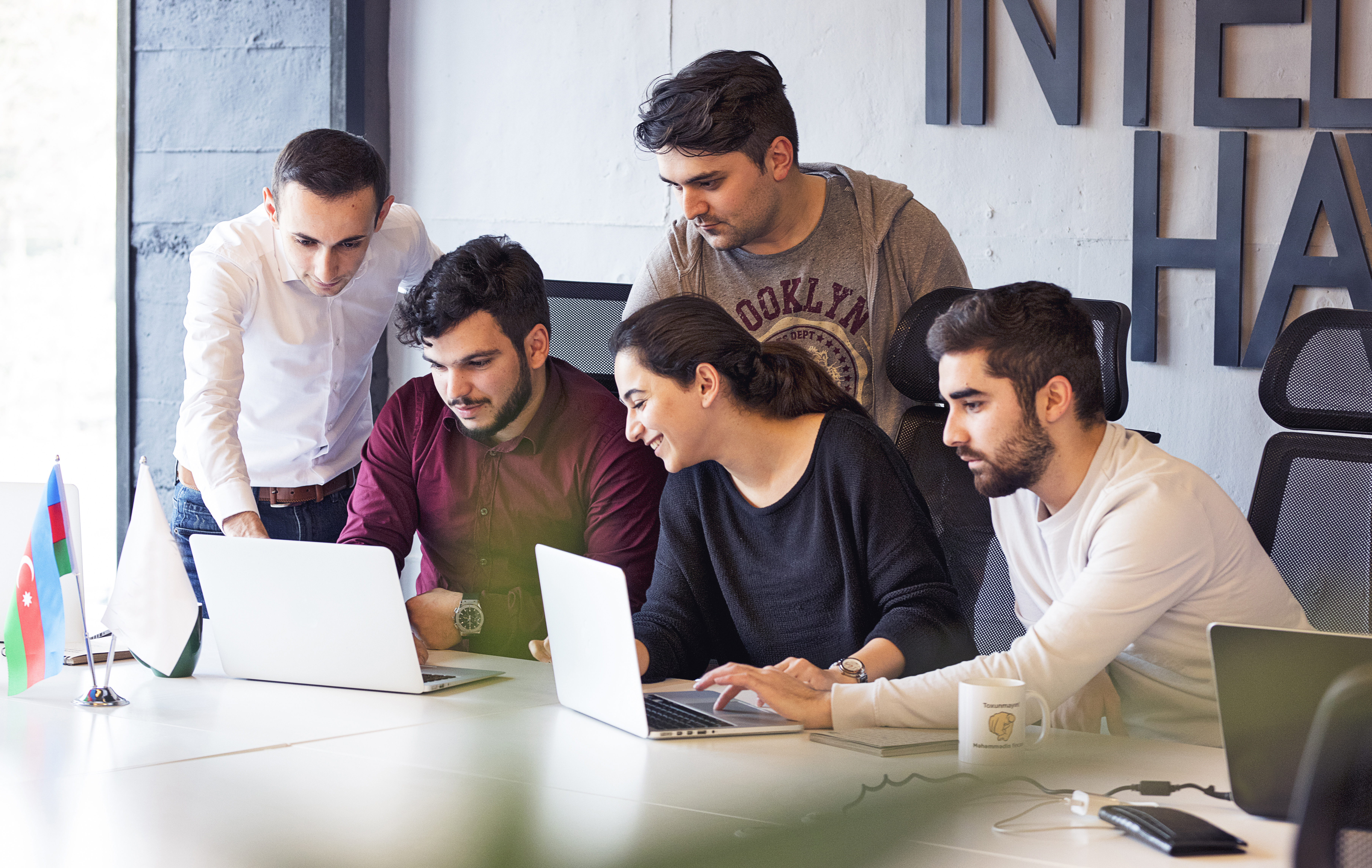 Senior software engineers collaborating on laptops in an office